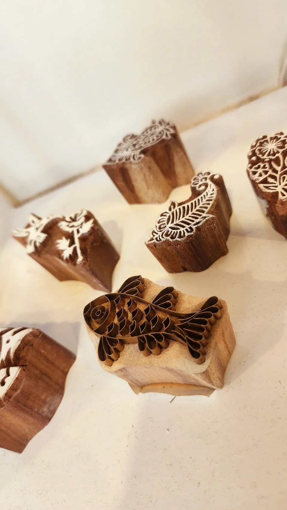 Hand-carved wooden printing blocks laid out on a white table