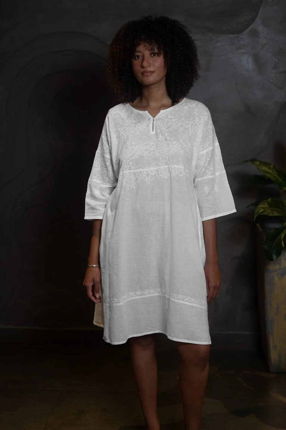 A white chikankari tunic with elbow-length sleeves, worn and seen from the front