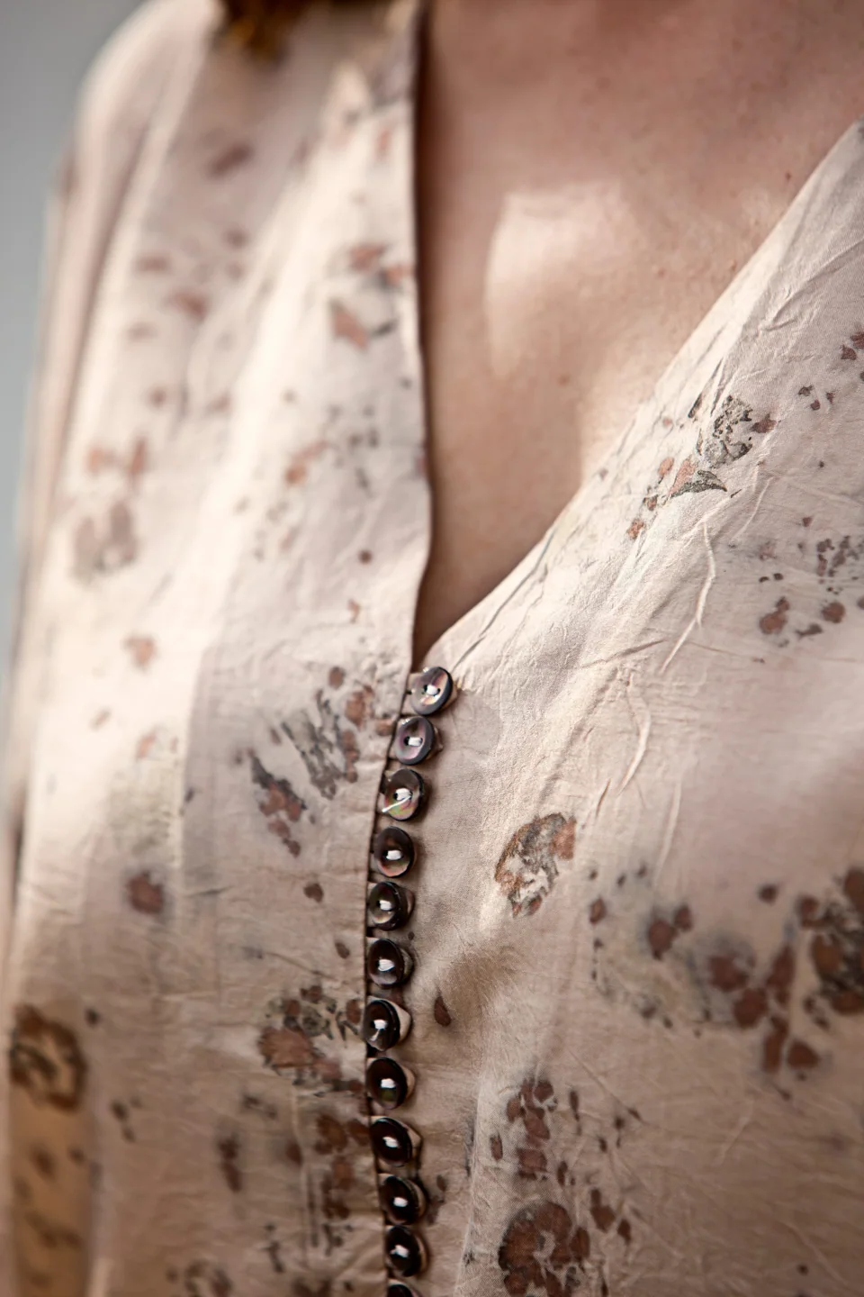 Eco-printed silk blouse with leaf shapes and a row of small buttons