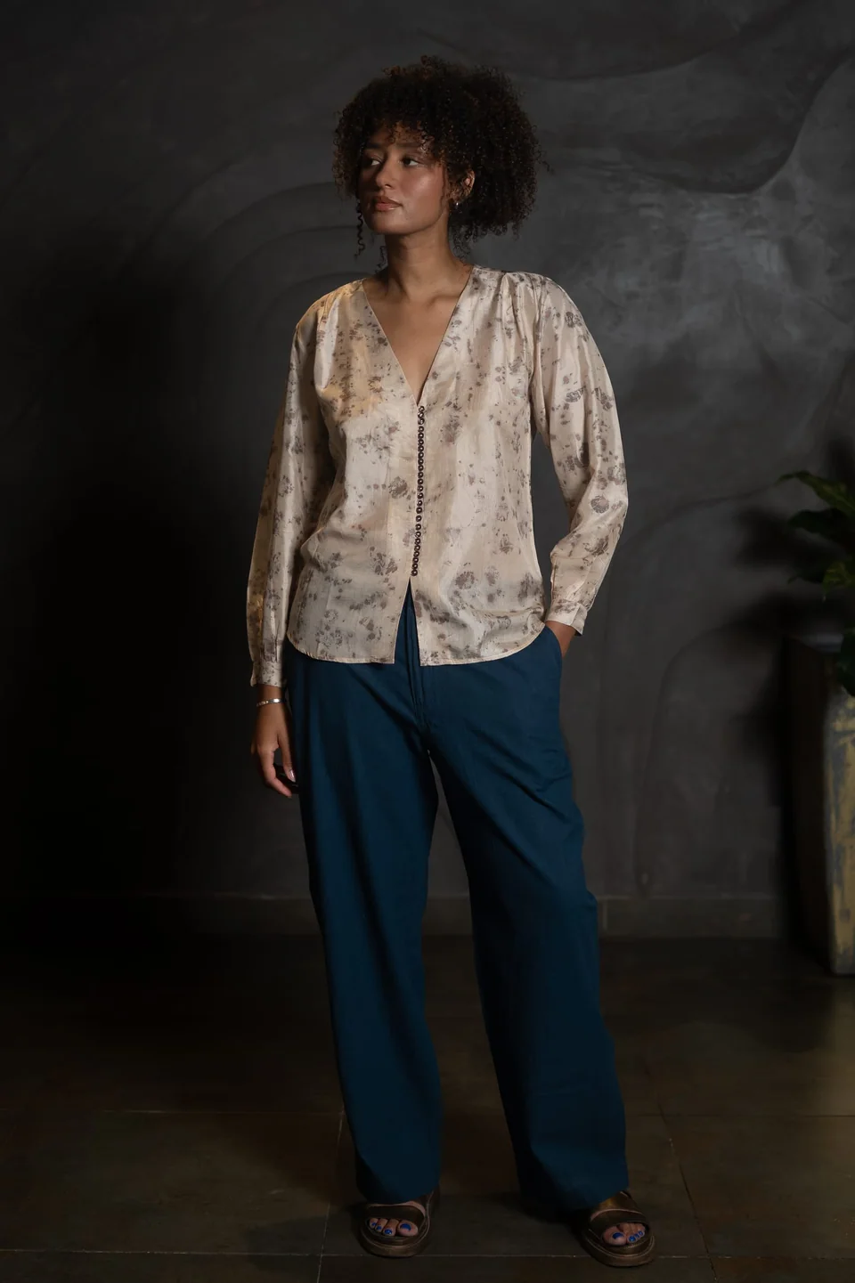 Eco-printed silk blouse in rose and stone worn open-collared with dark blue trousers