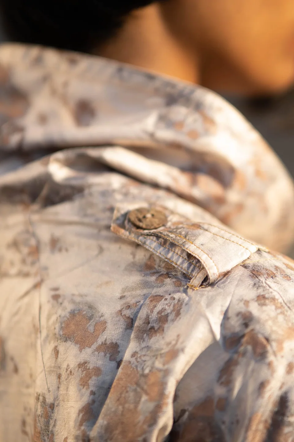 Eco-printed silk at the shoulder, botanical shapes in soft grey and rust