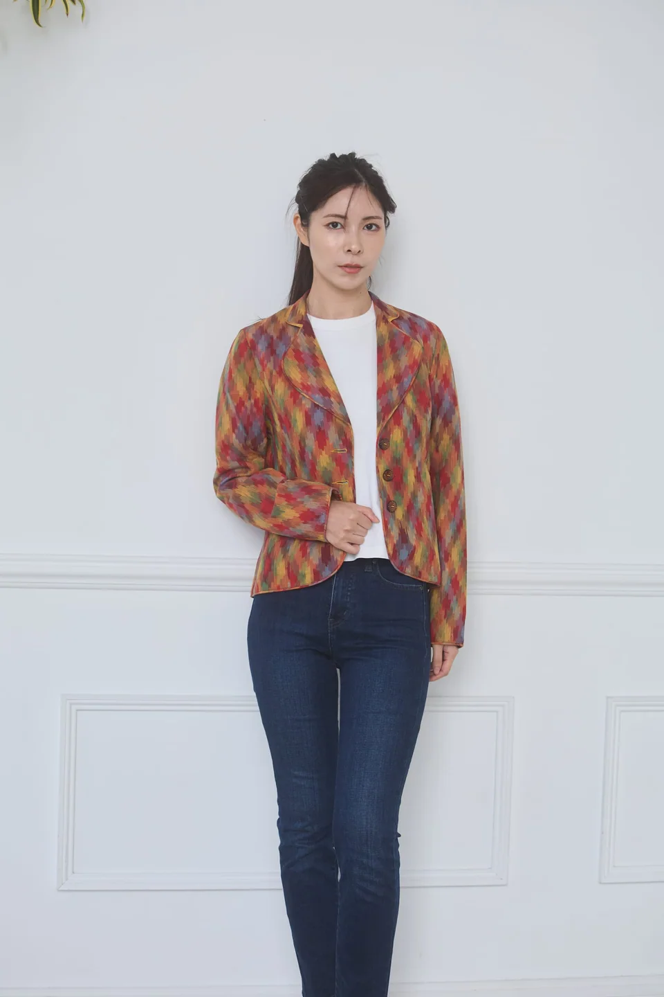 Full-length view of the multicolour ikat jacket, standing against a white wall