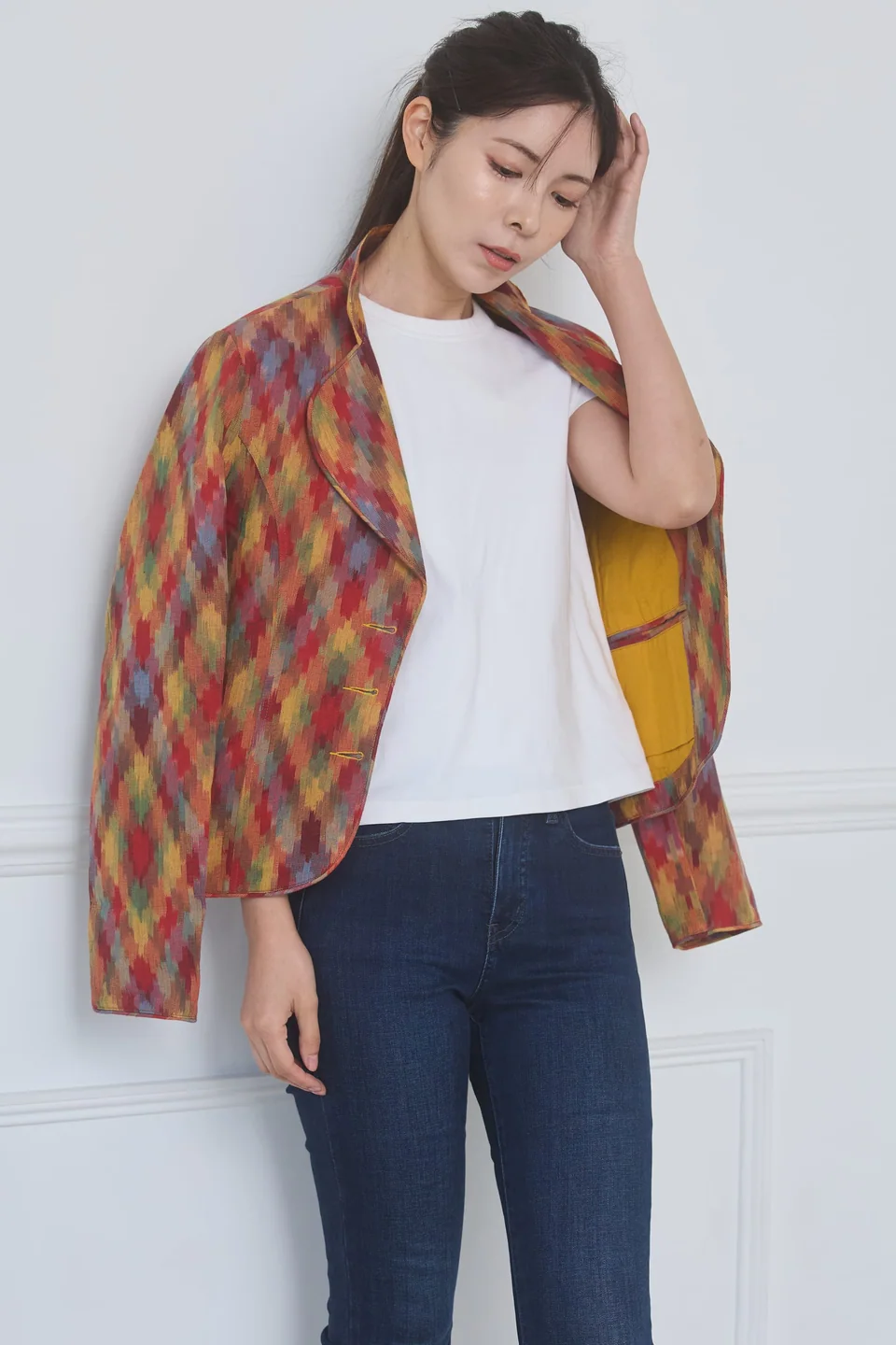 The ikat jacket swung open to show its yellow lining