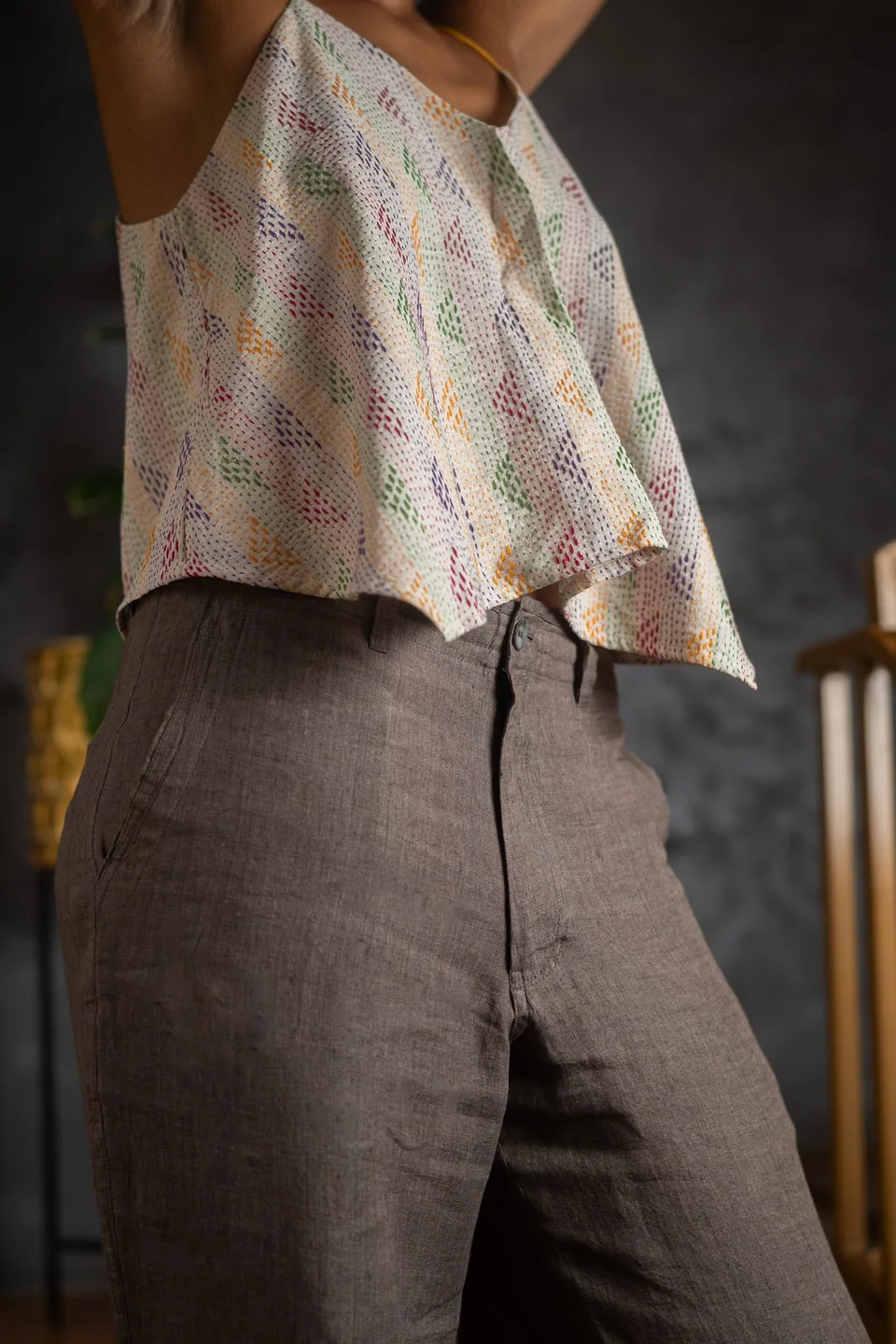 Hem of the cotton kantha cami over soft brown linen trousers