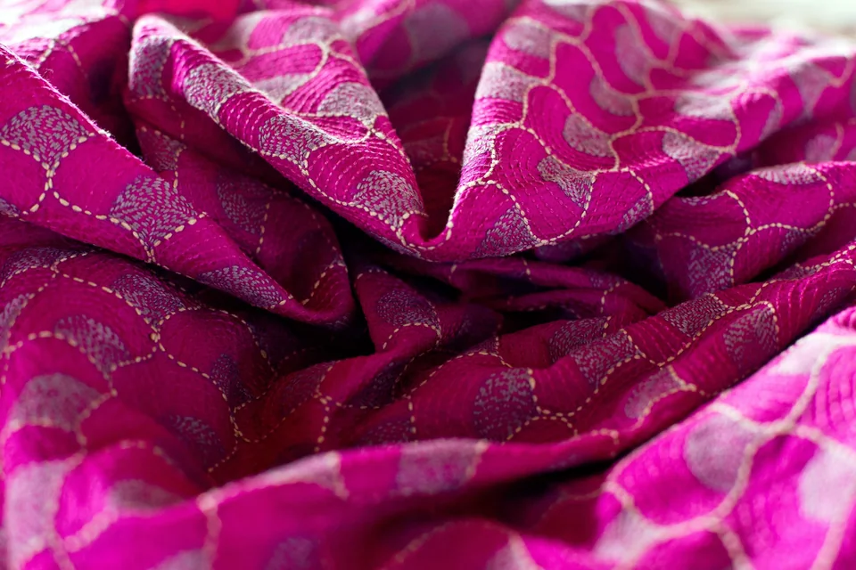 Close view of the magenta kantha dress cloth and its stitch