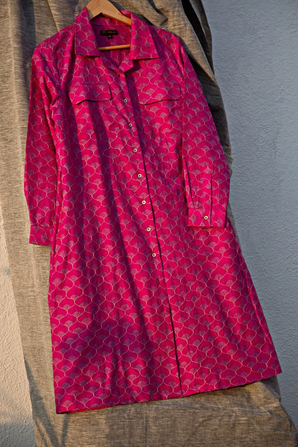 Magenta kantha shirt dress hanging in evening light