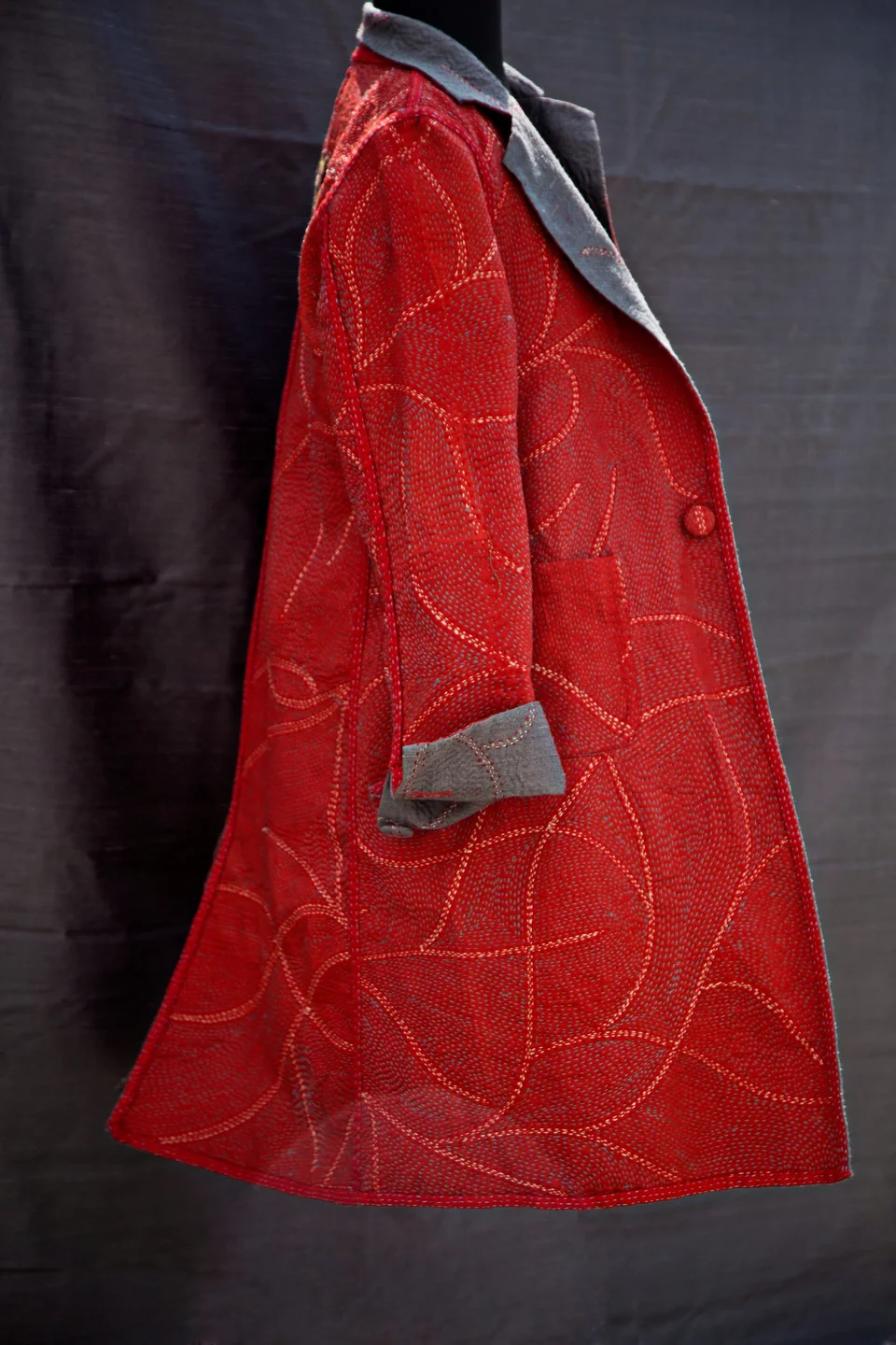 The reversible kantha coat from the side, grey turned back at the cuff