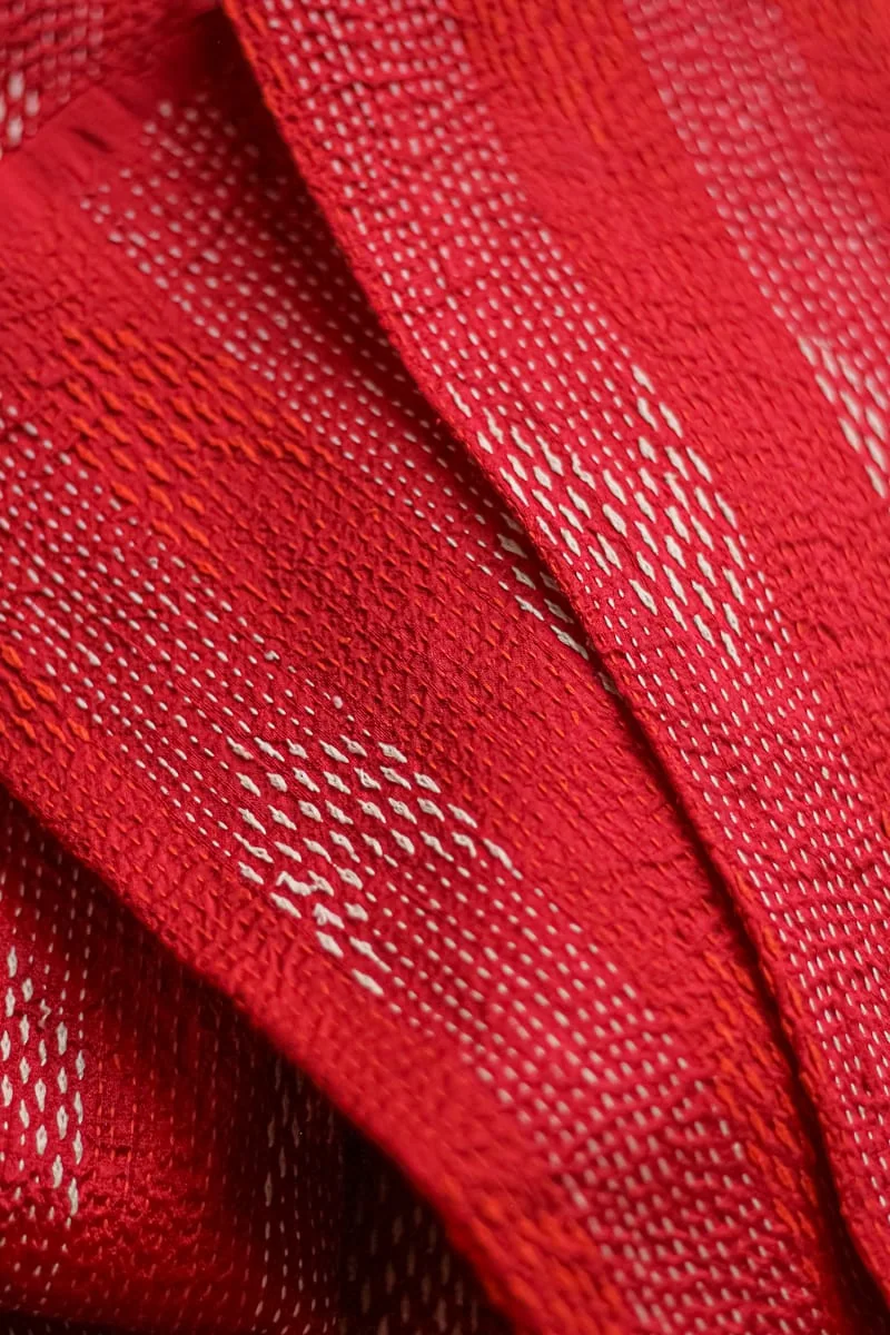Red silk covered in white kantha running stitch